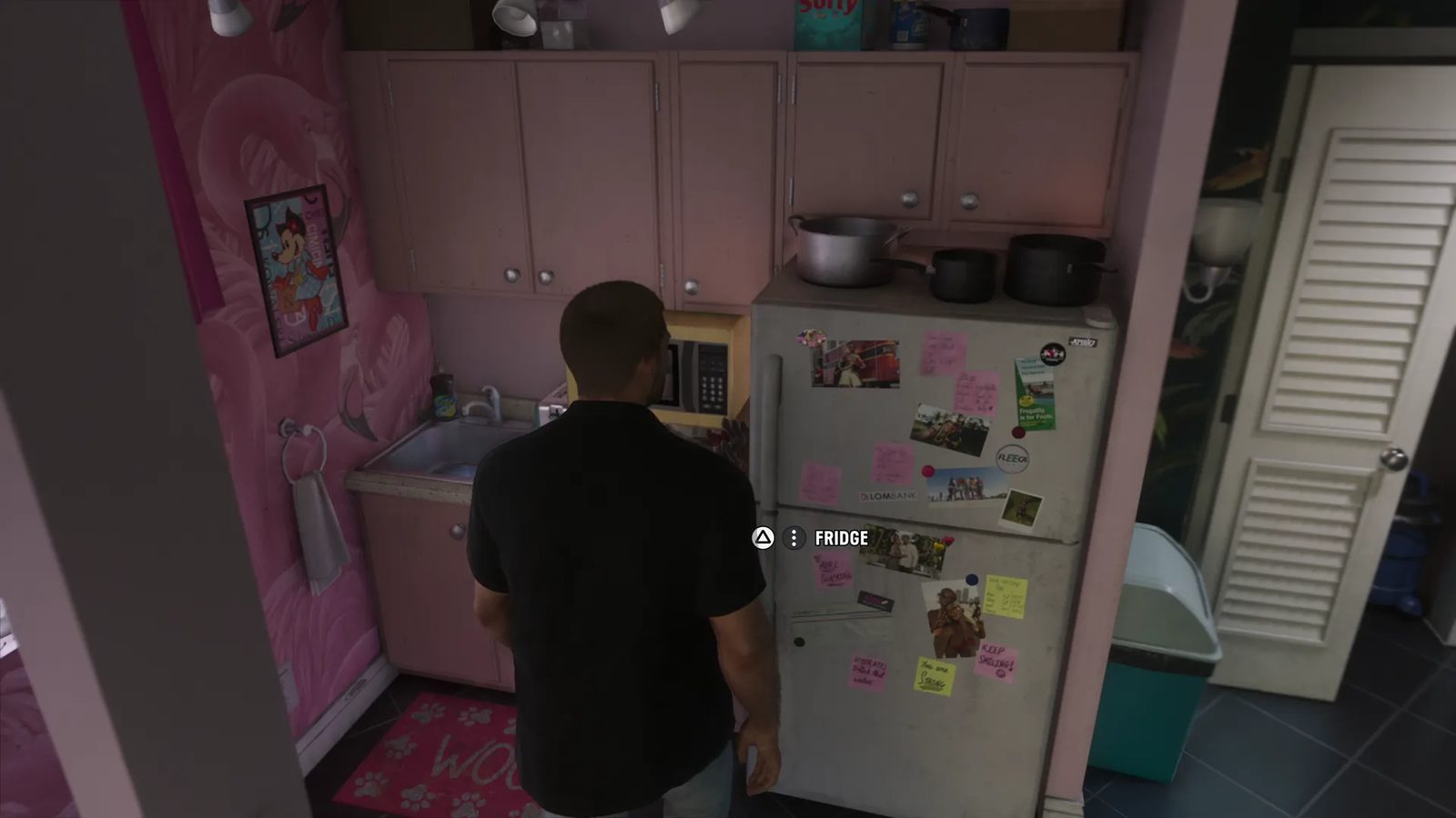 A man in a black shirt, seen from behind, stands at a magnet-covered fridge in a small pink kitchen with a "FRIDGE" prompt on screen.