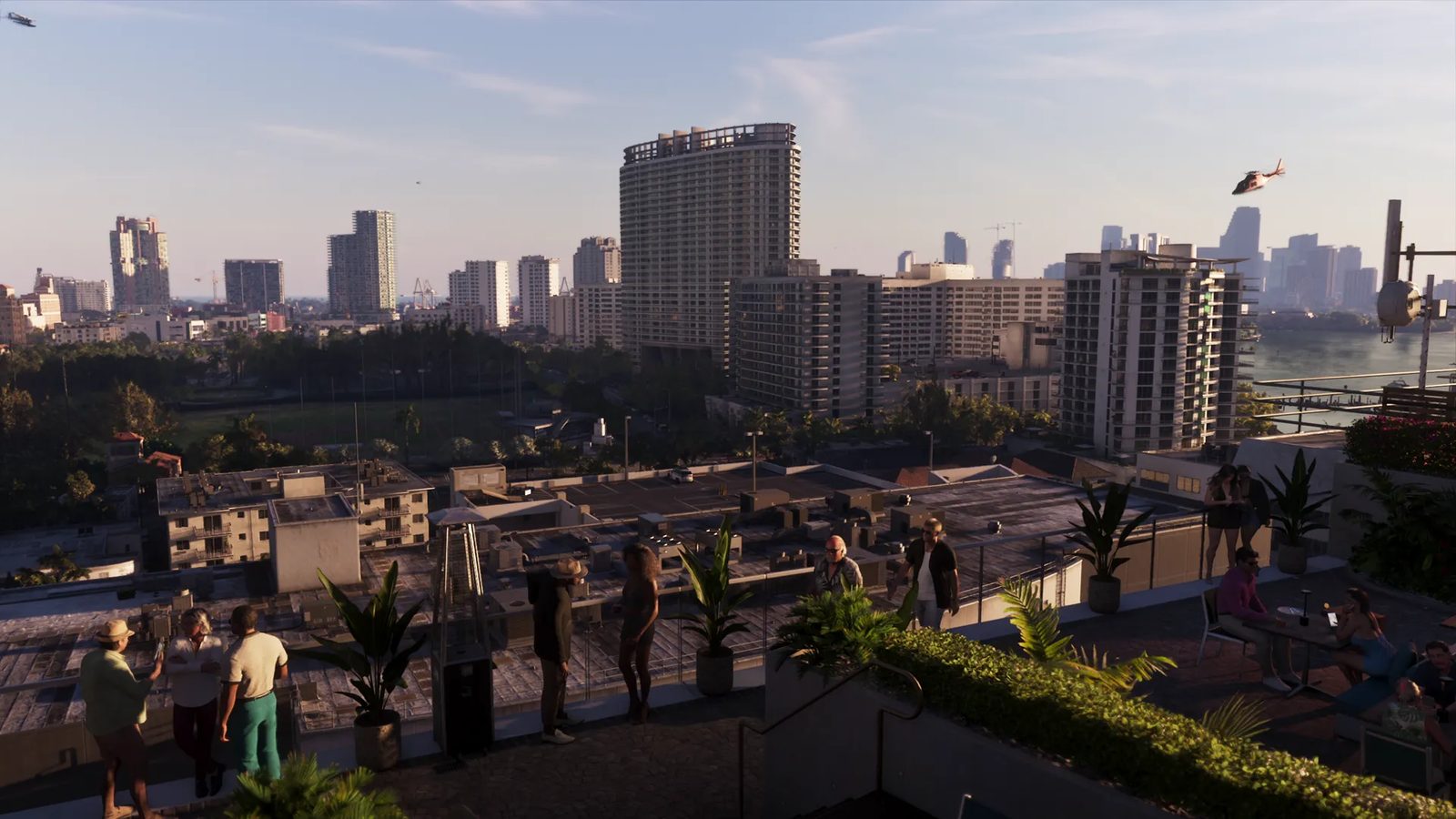 People gather on a plant-filled rooftop terrace at golden hour, overlooking high-rise buildings and a waterfront in Vice City, with a helicopter in the sky.