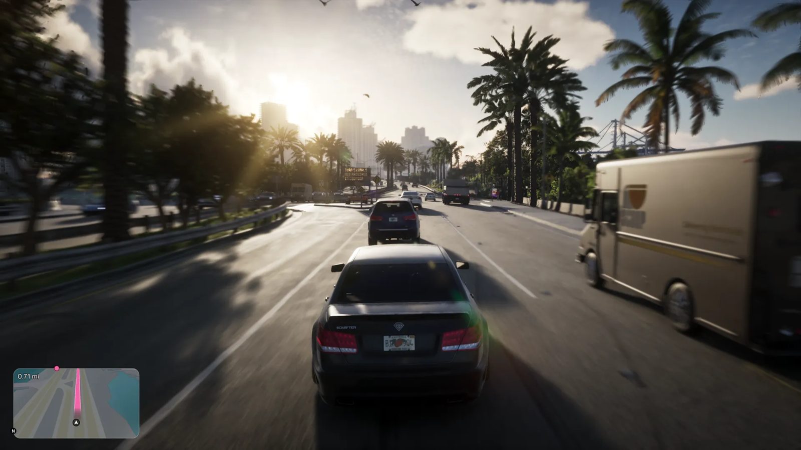 A dark grey saloon car drives along a sunlit palm-lined road in Vice City, with a brown Brute Boxville delivery van alongside.