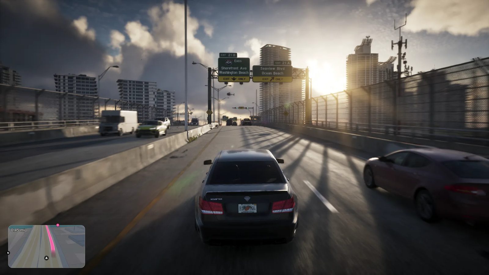 A dark grey saloon car drives along a elevated highway towards a low sun, passing exit signs for Shorefront Ave and Seaview Blvd, with tower blocks beyond.