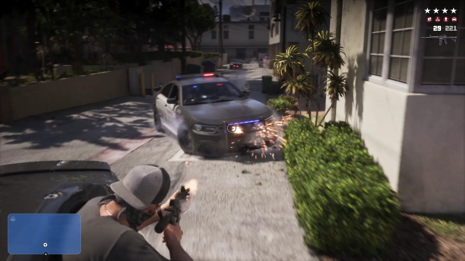 A man in a grey cap crouches behind a dark car and fires a rifle at a police car skidding towards him down a sunlit alley, sparks flying.