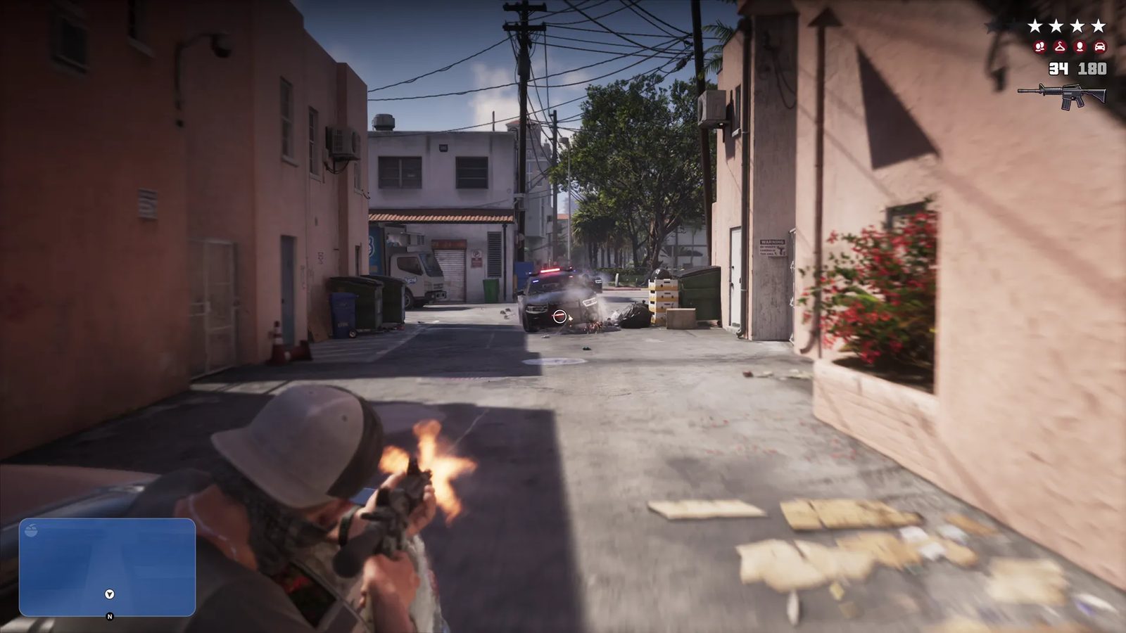 A man in a pale helmet fires a rifle down a sunlit back alley at a police car, with a four-star wanted level shown at top right.