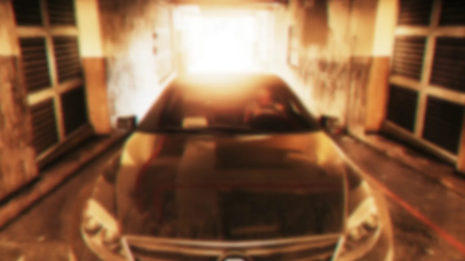 A dark car faces the camera in a grimy, narrow concrete passage, with a bright orange light glowing at the far end.