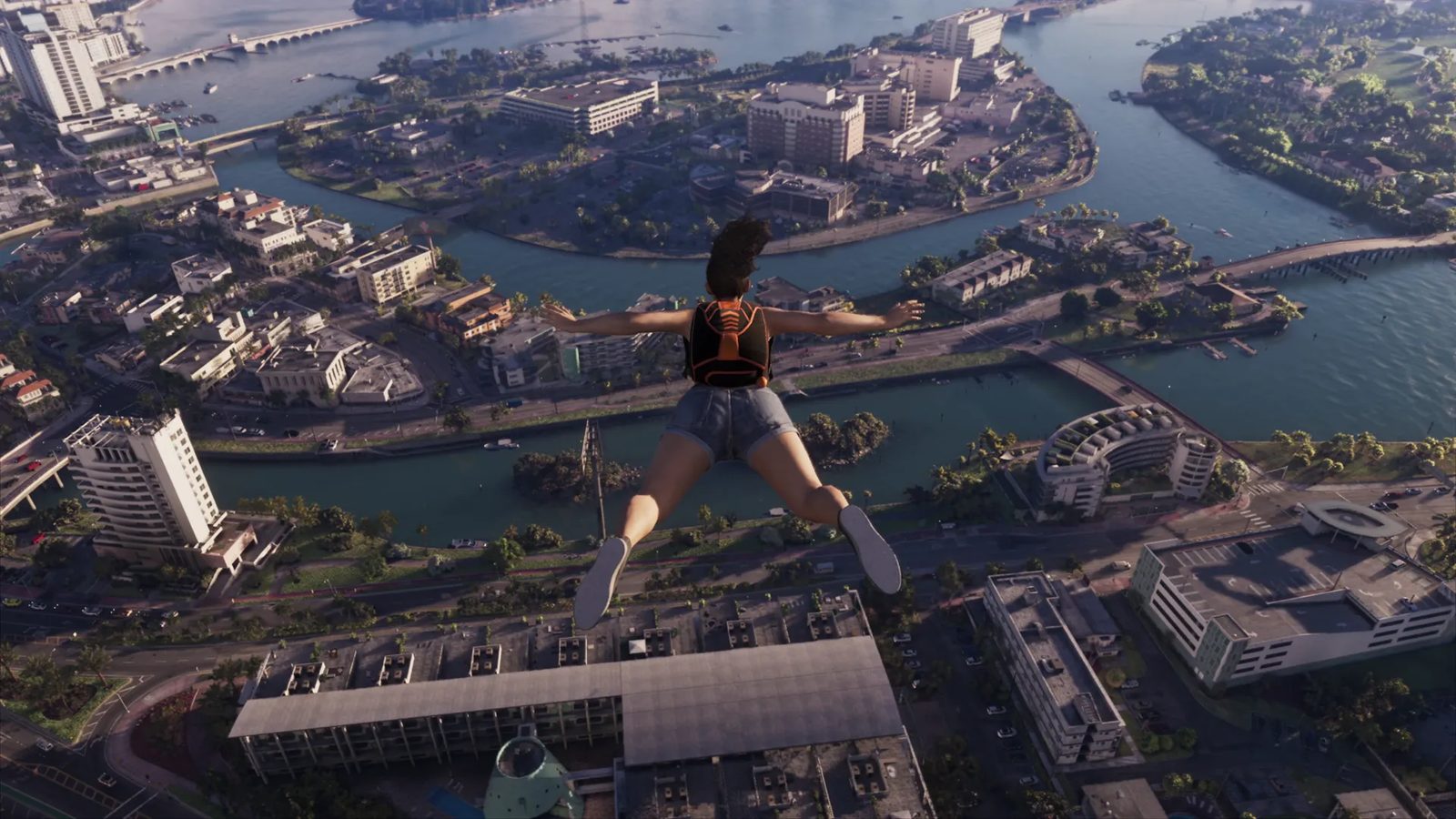 A woman in denim shorts and an orange-and-black backpack skydives with arms spread over Vice City's islands, canals and buildings.