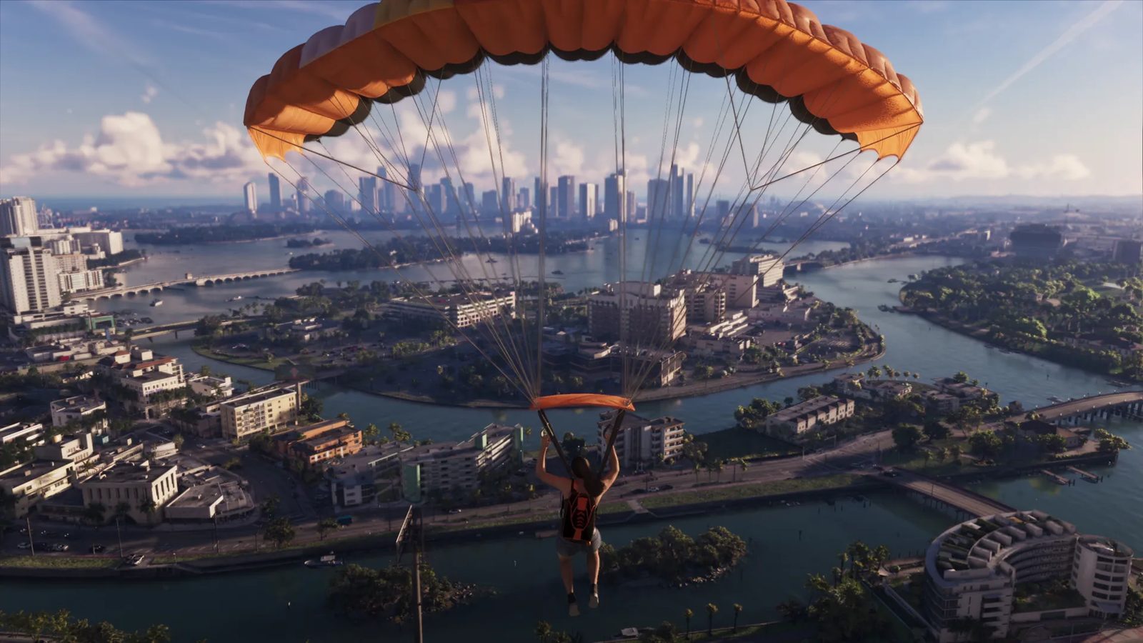 A person in shorts and a dark backpack glides under an orange parachute above Vice City, with islands, canals and bridges below and towers ahead.