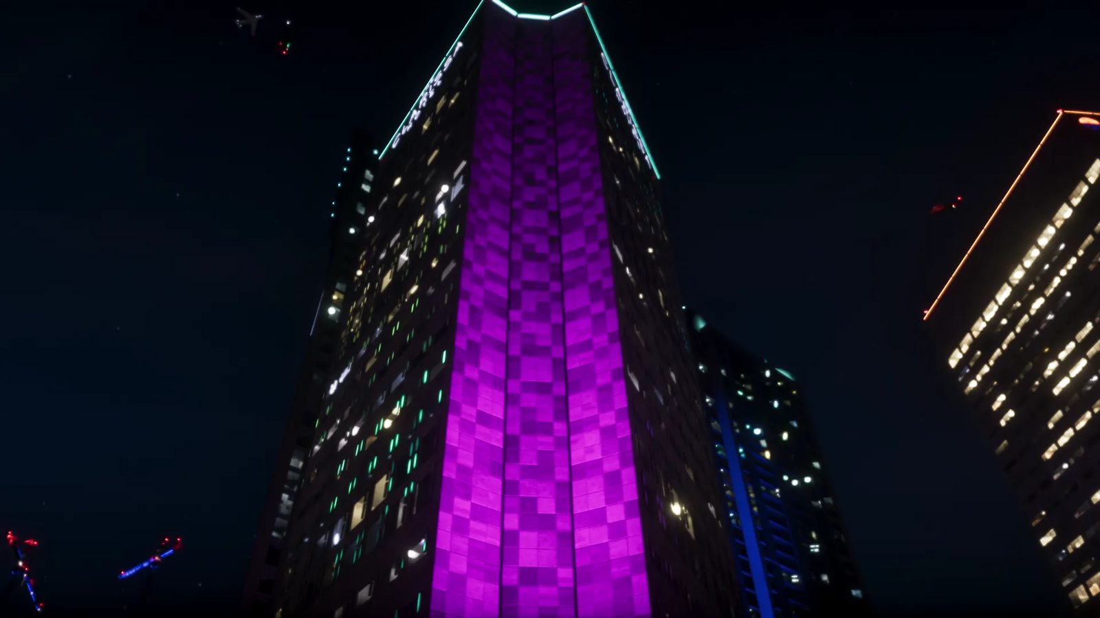 Looking up at a tall skyscraper at night, its middle glowing purple in a checked pattern, with a teal-lit crown and other lit towers beside it.