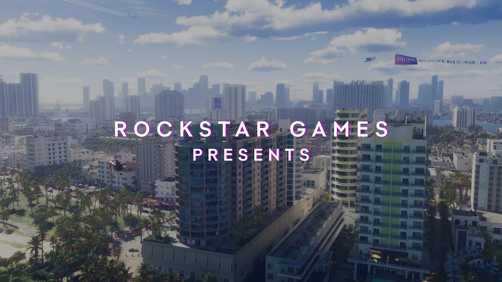 Aerial view of high-rise buildings and palm-lined streets in Vice City, with the words "Rockstar Games Presents" across the middle.