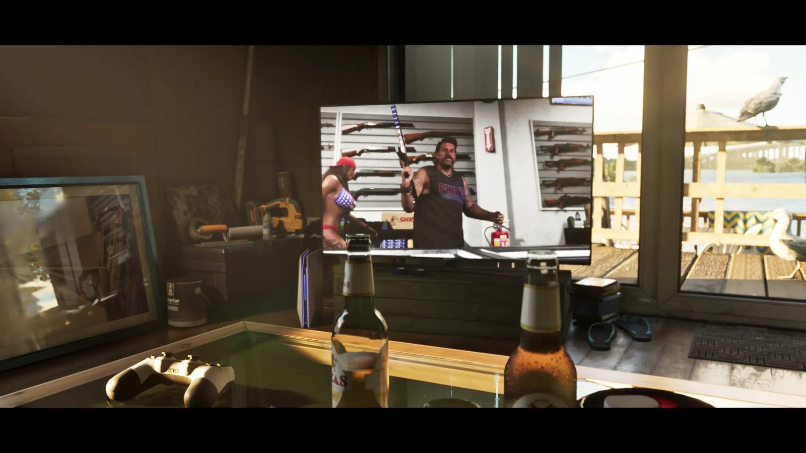 A television in a sunlit waterside room shows Phil, a bearded man in a black vest, holding a rifle in a gun shop, with beer bottles in front.