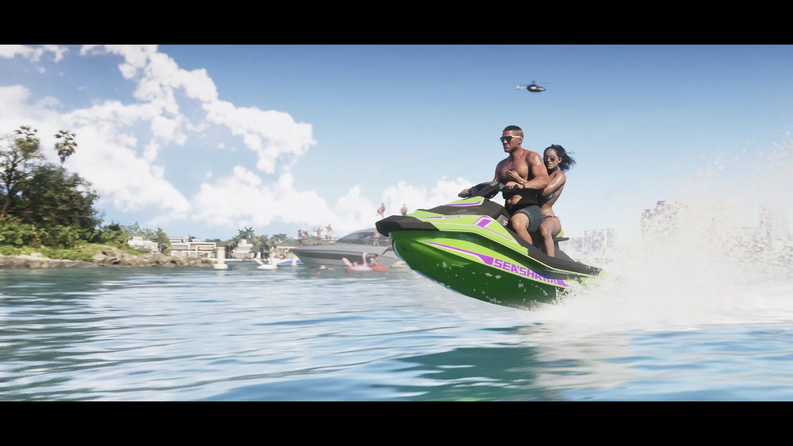 A shirtless man and a woman in sunglasses ride a green and purple Speedophile Seashark jet ski across blue water, with a helicopter overhead.