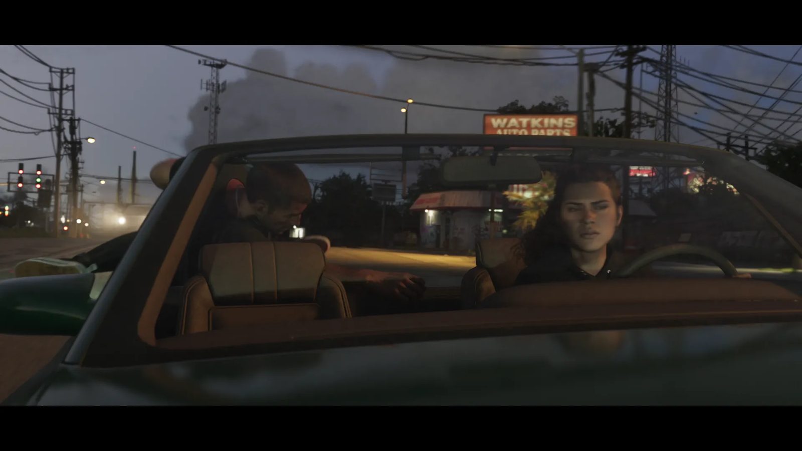 Lucia Caminos drives a dark green convertible at dusk, with a man slumped in the back seat, past a Watkins Auto Parts sign.
