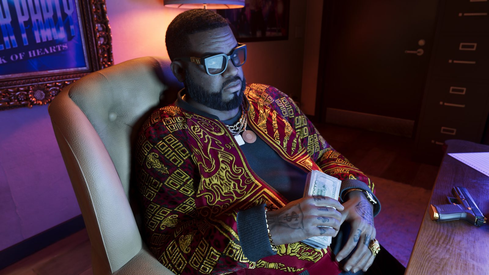 Boobie Ike, a bearded man in tinted glasses and a red and gold jacket, sits in an armchair holding a wad of cash, with a handgun on a desk beside him.