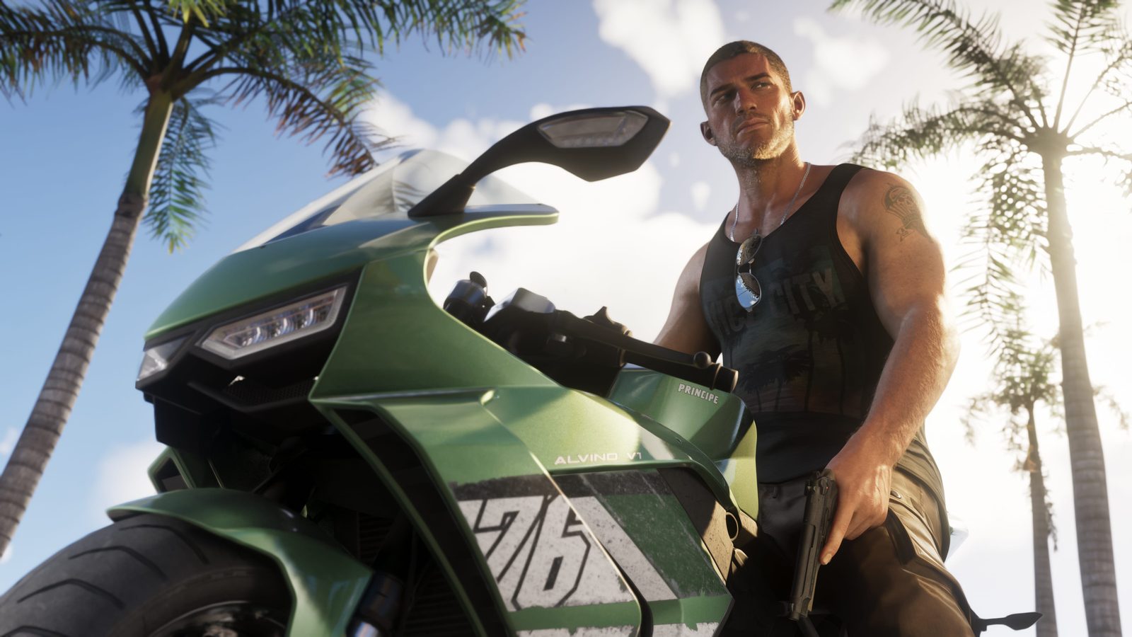 Jason Duval sits on a green Principe Alvino V1 motorbike, holding a handgun, beneath tall palm trees in bright sunshine.