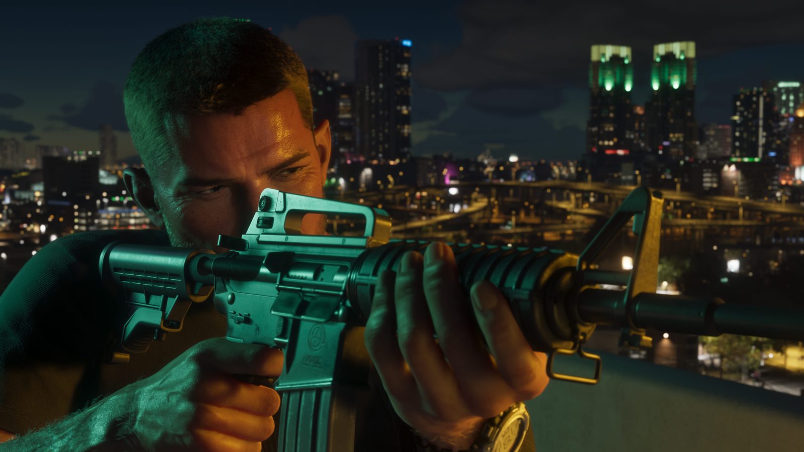Jason Duval aims a Duke Arms 556 rifle on a rooftop at night, with a lit city skyline and elevated highways behind him.