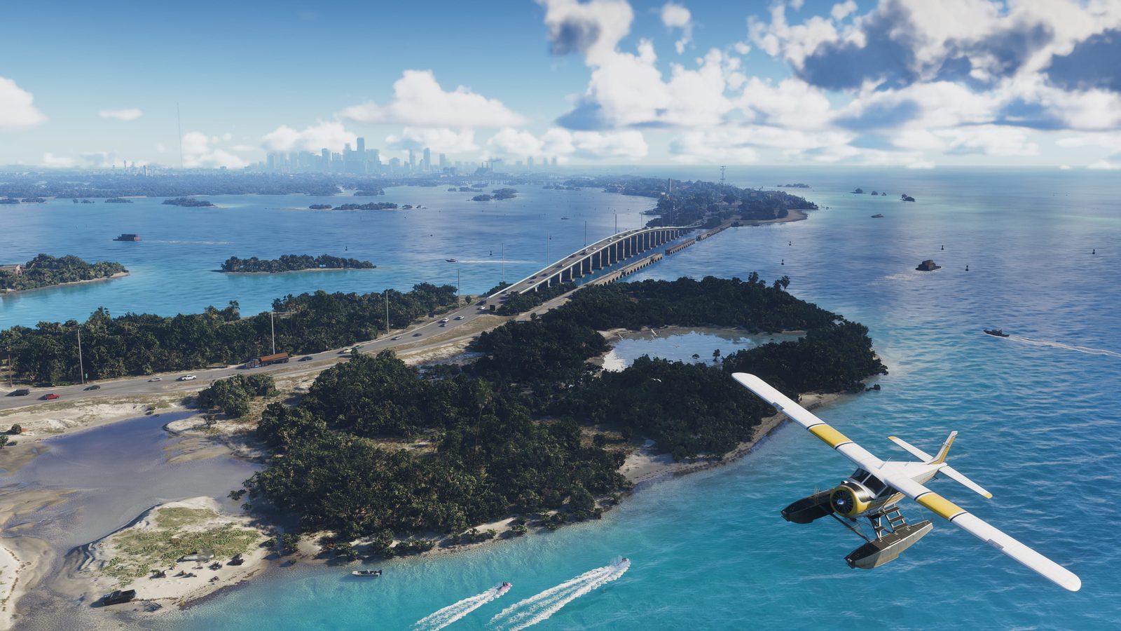 A white and yellow Mammoth Dodo seaplane flies over turquoise water and wooded islands in the Leonida Keys, with a long bridge and city skyline beyond.