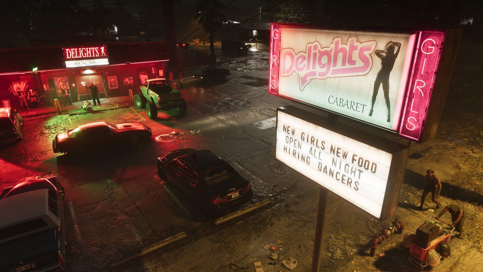 A pink neon Delights Cabaret sign and a lit message board over a wet car park at night, with a strip club and parked cars beyond.