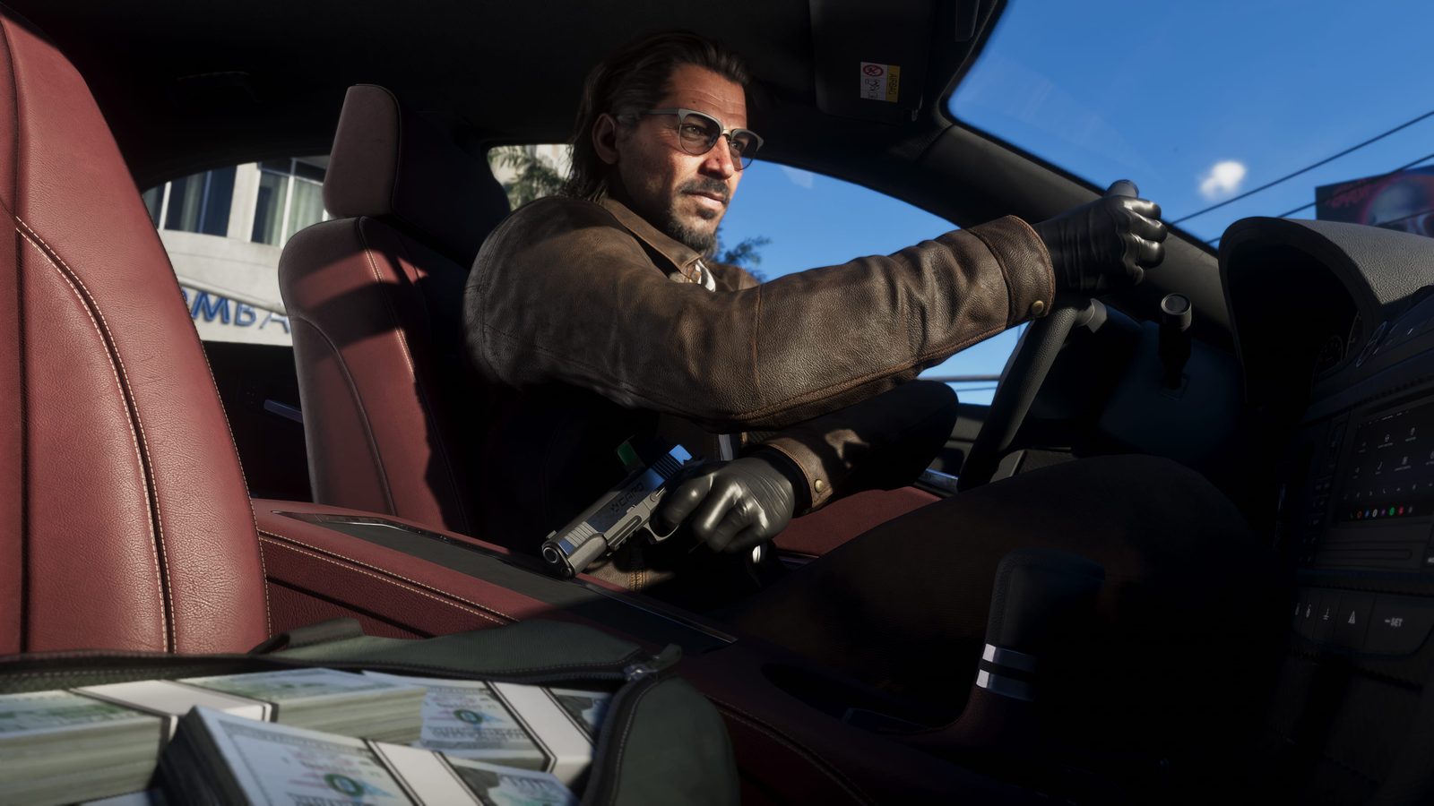 Raul Bautista, in sunglasses and a brown leather jacket, drives a car with a pistol in one hand and a bag of cash on the seat beside him.
