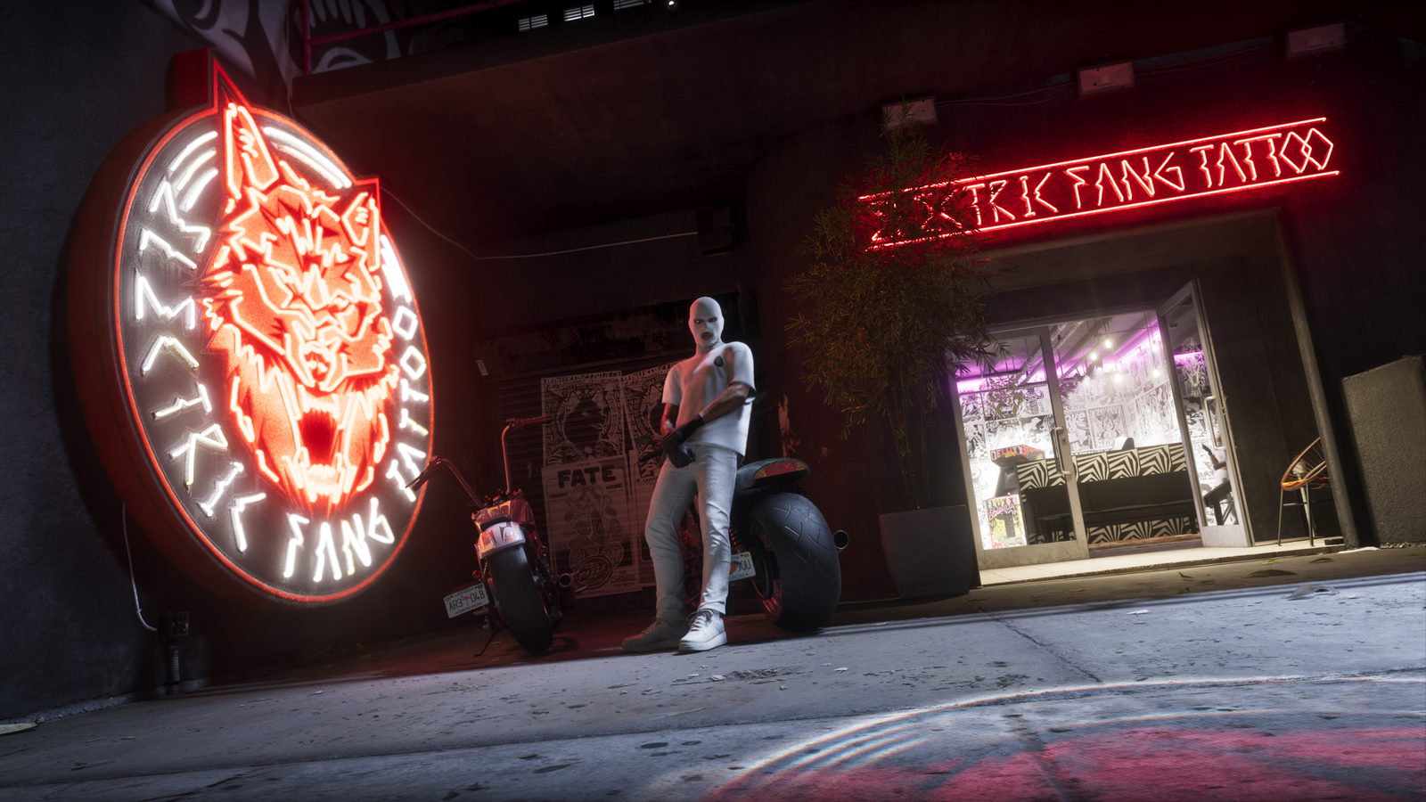 A masked figure in white leans on a motorbike outside the neon-lit Electric Fang Tattoo shopfront at night.