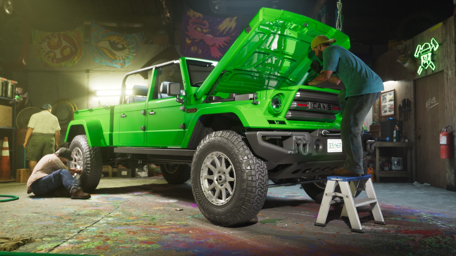 A man on a step ladder works under the raised bonnet of a bright green Canis pickup in a cluttered, paint-splattered garage.