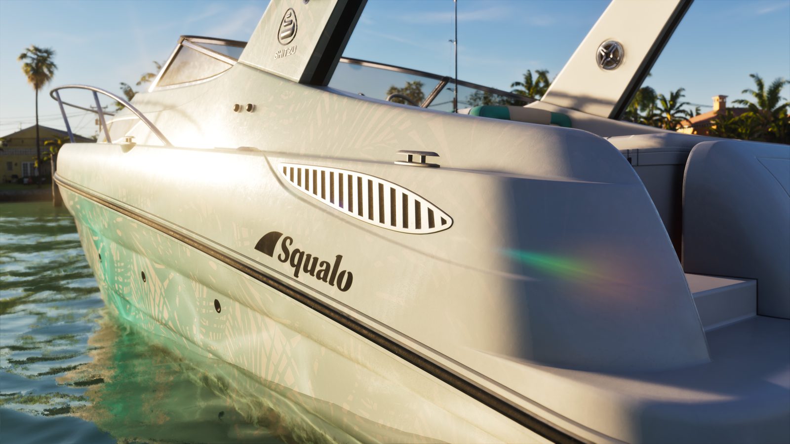 Close view of the stern of a white Shitzu Squalo motorboat with a palm-leaf pattern, floating on green water beside waterfront houses and palm trees.