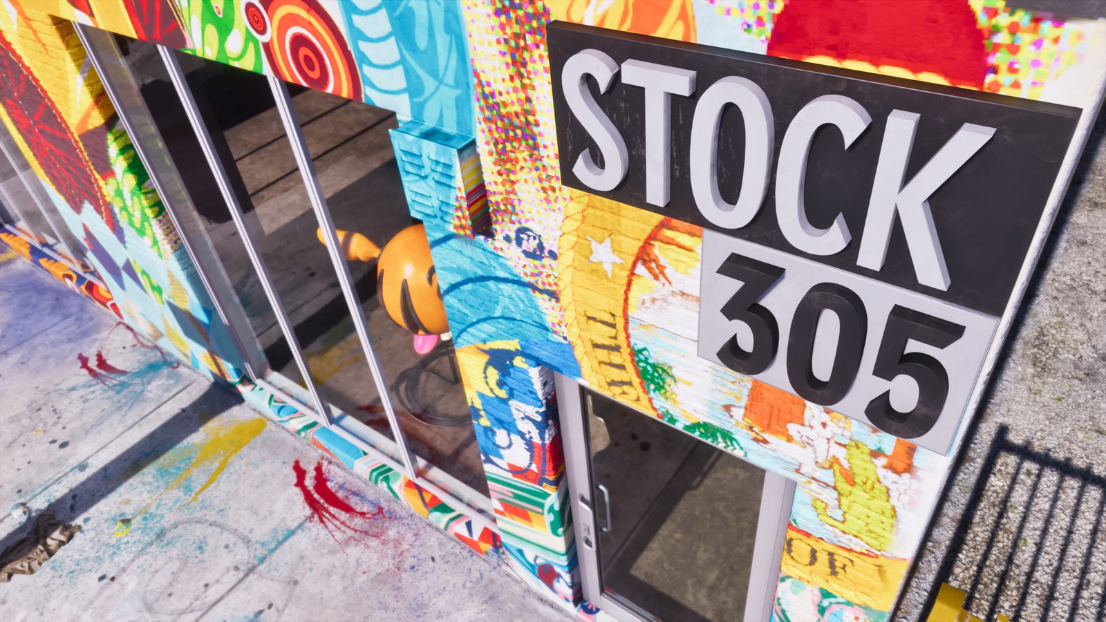 The Stock 305 shop front, covered in colourful murals, with a large grey sign above a glass door and windows, seen from the pavement in bright sun.