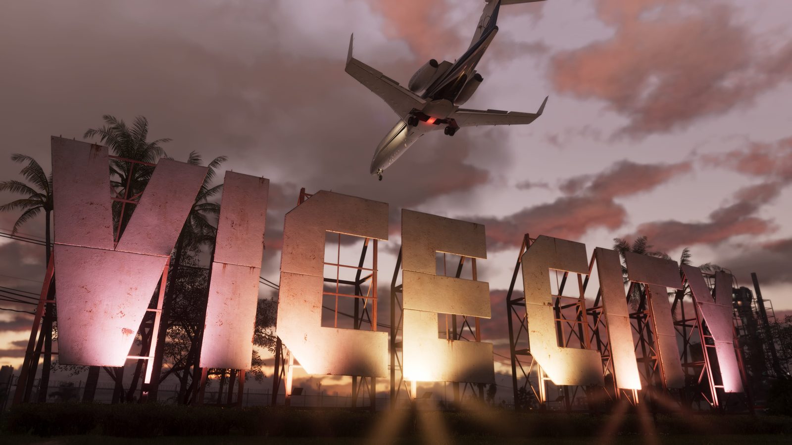 A small jet flies low over the large, lit Vice City Sign, with palm trees and a pink-orange cloudy sky behind it at dusk.
