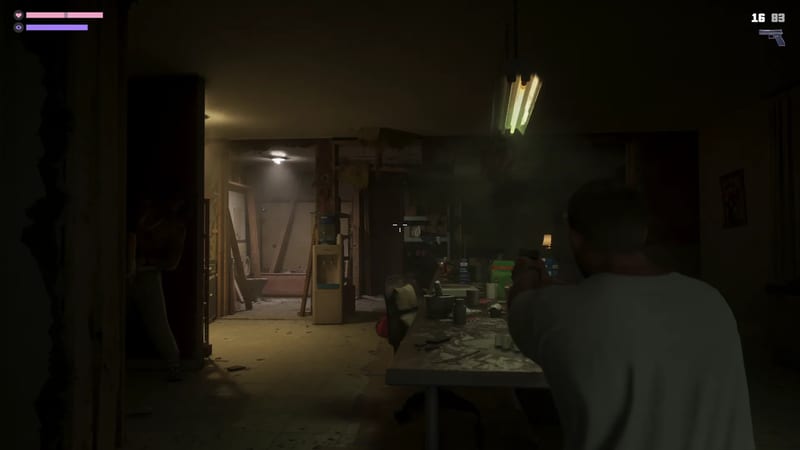 A man in a white t-shirt, seen from behind, aims a pistol across a cluttered table in a dim, half-demolished room.