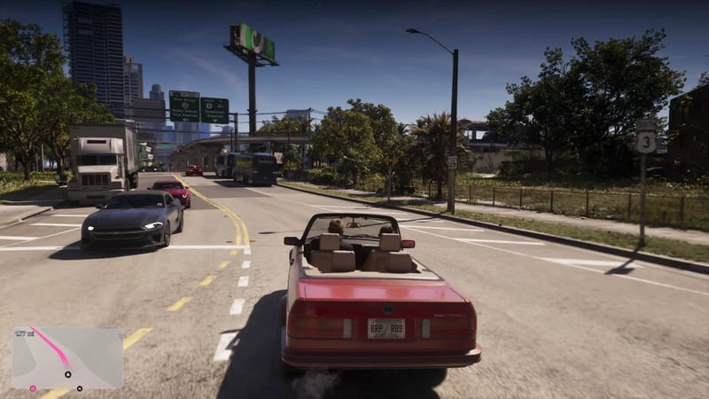 A red convertible with two people in it drives along a sunny multi-lane road in Vice City, with traffic ahead and tall buildings in the distance.
