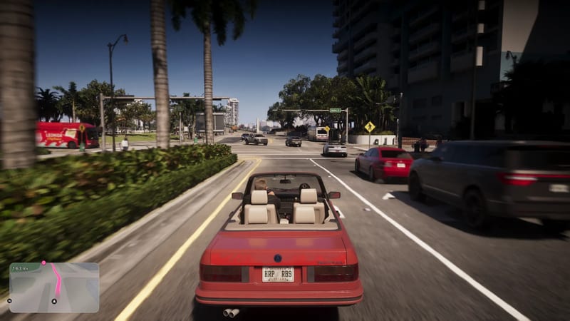 A red convertible with cream seats drives along a sunny palm-lined street in Vice City, with traffic ahead and a tall apartment block on the right.