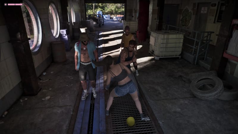 A woman in denim shorts and a dark top is grabbed by a man in a vest, while two other men watch in a derelict, dimly lit car wash.