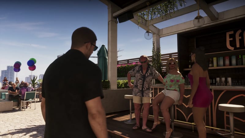 A man in a black shirt and sunglasses faces a rooftop bar where three people stand and sit by the counter, with a city skyline behind under a blue sky.