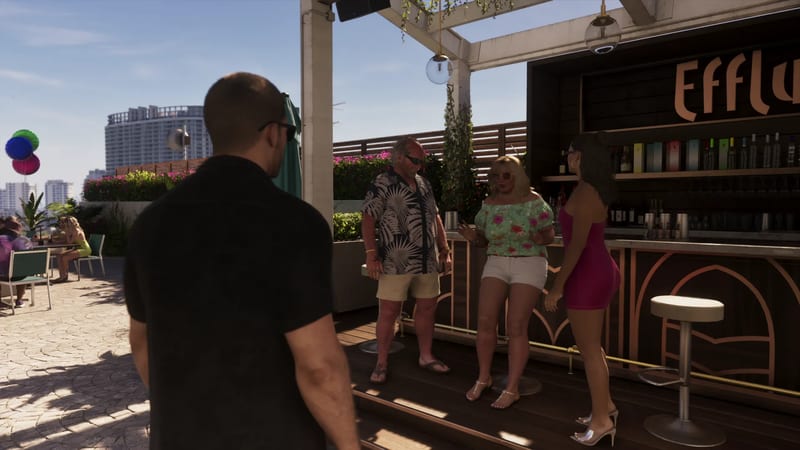A man in a black shirt watches three people talk beside the Effluvia rooftop bar on a sunny day, with a city skyline behind.