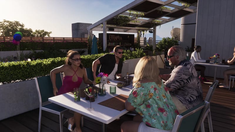 Four people sit at a white table on a sunny rooftop terrace, with a bar sign reading Effluvia behind them.