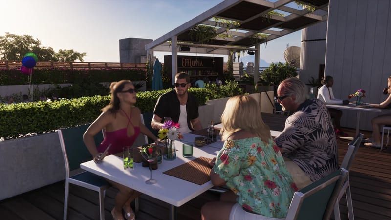 Four people sit at a white table on a sunny rooftop terrace, with an Effluvia bar sign behind them and hedges and a pergola around them.