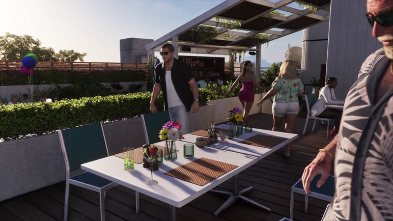 Diners and staff move around a white table set with flowers on a sunny rooftop terrace, with an Effluvia bar sign in the background.