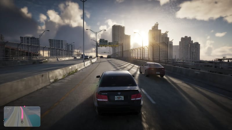 A dark saloon car with a Schafter badge drives along an elevated Vice City highway towards high-rise towers at sunset, with a red car beside it.