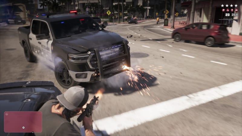 A man in a grey cap crouches behind a car and fires a rifle at a black and white police pickup on a sunlit Vice City street, with sparks flying.