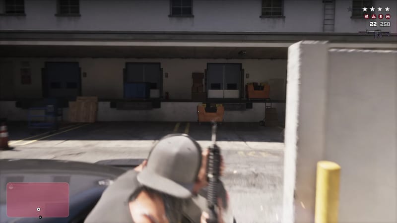 A person in a grey cap crouches behind a car, aiming a rifle across a loading bay with a four-star wanted level shown in the corner.