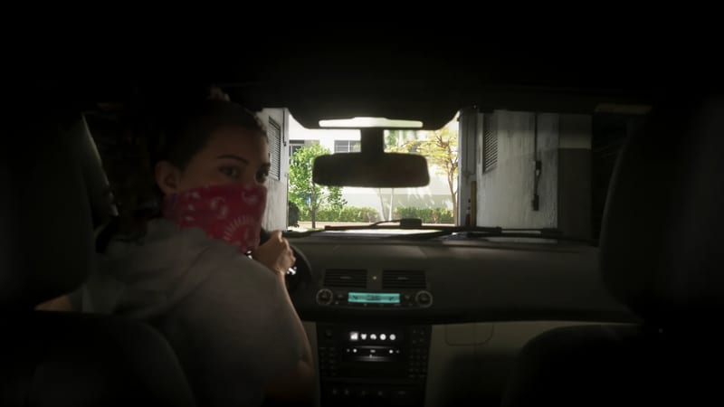 Lucia Caminos, wearing a red bandana over her face, looks back from the driver's seat of a car inside a dim car park, with a sunlit street ahead.