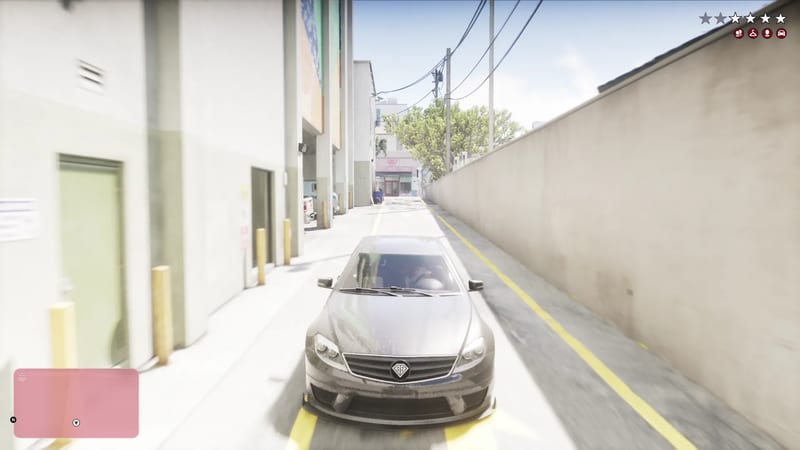 A dusty grey saloon car drives down a narrow, sunlit alley between a white building and a tall concrete wall in Vice City.