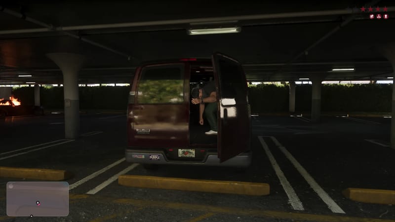 A man in a cap and green trousers steps out of a dark red Declasse Burrito van parked in a dimly lit multi-storey car park in Vice City.