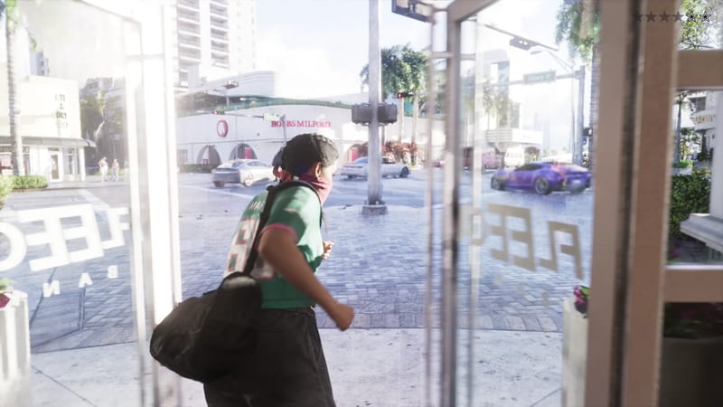 A woman in a green jersey and pink bandana over her face, carrying a black bag, runs out through glass doors onto a sunny city street.
