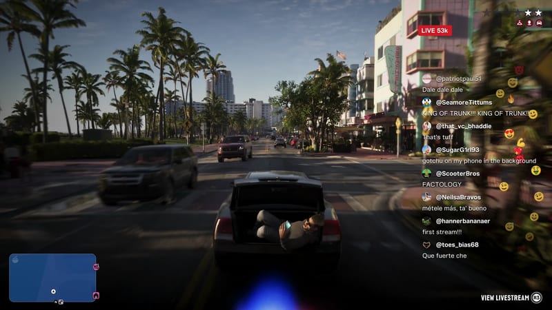 A man in sunglasses lies in the open boot of a moving grey car on a palm-lined city street, with a live-stream chat panel on screen.