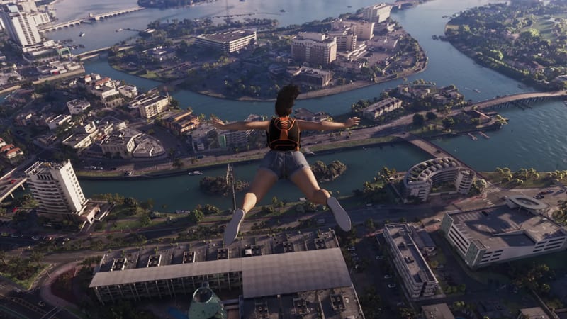 A woman in denim shorts and an orange-and-black backpack skydives with arms spread over Vice City's islands, canals and buildings.