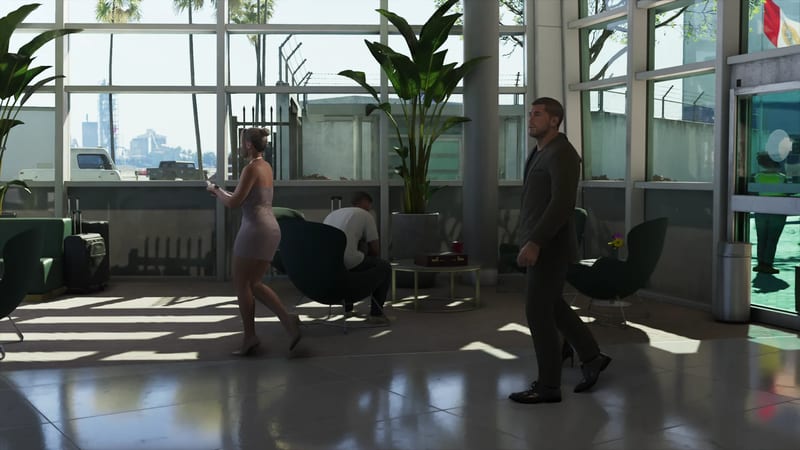 A man in a dark suit walks through a bright airport terminal while a woman in a pink dress passes and a seated man looks down, with luggage and plants around.