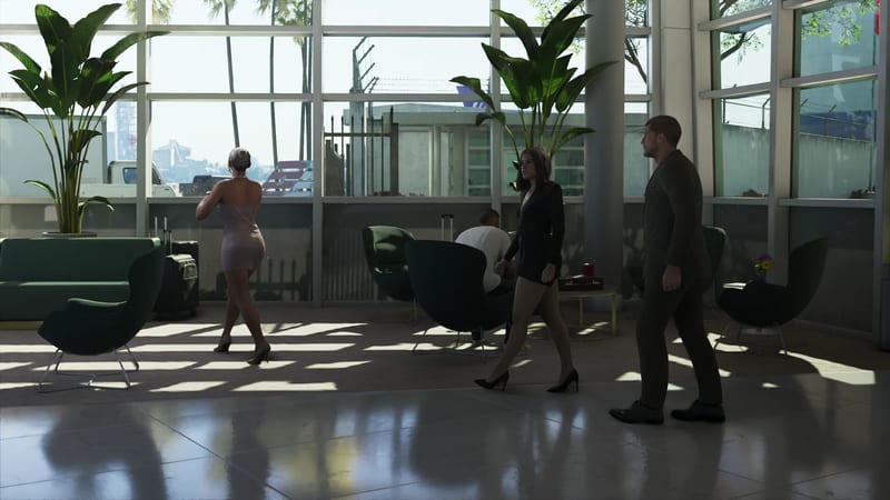 People walk through a bright airport terminal with green armchairs and large plants, beside tall windows overlooking the airfield and palm trees.