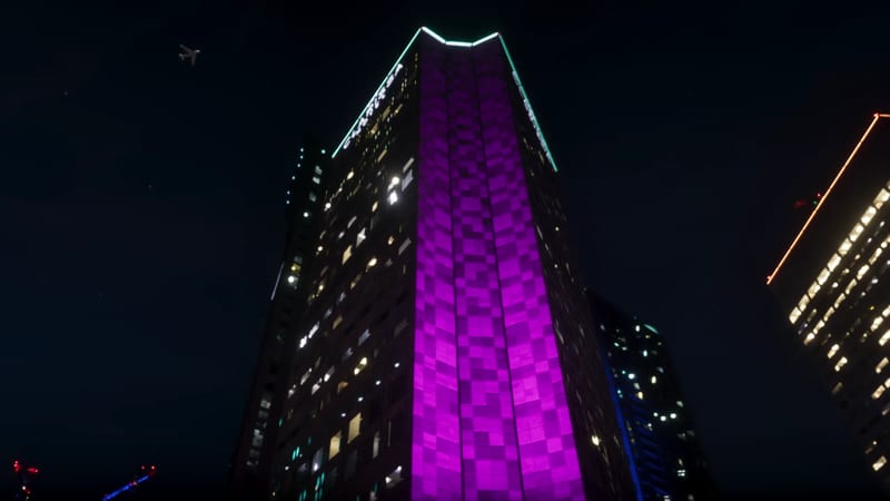 A tall skyscraper lit with a purple checkerboard pattern towers over the viewer at night, with a small jet in the dark sky.