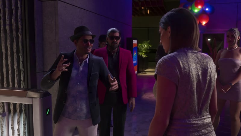 A man in a fedora and sunglasses gestures to a woman in a silver dress at an entrance, with a bearded man in a red jacket behind him.