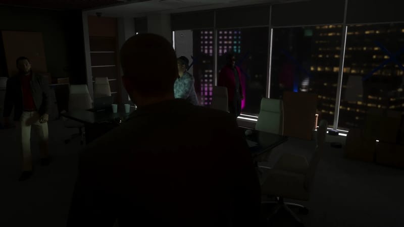 A dark, dim office at night with a bald man seen from behind facing three people near a meeting table and tall windows overlooking a lit city skyline.