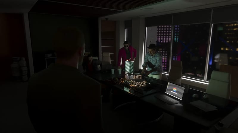 Three men gather around an illuminated tower model on a boardroom table in a dark office, with a city lit up at night beyond the windows.