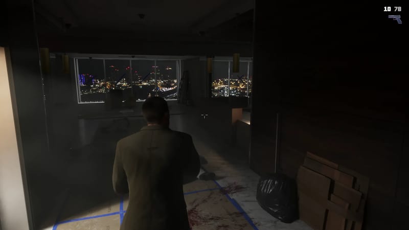 Seen from behind, Jason Duval stands in a dark, unfinished high-rise office at night, looking out over a glittering city skyline.